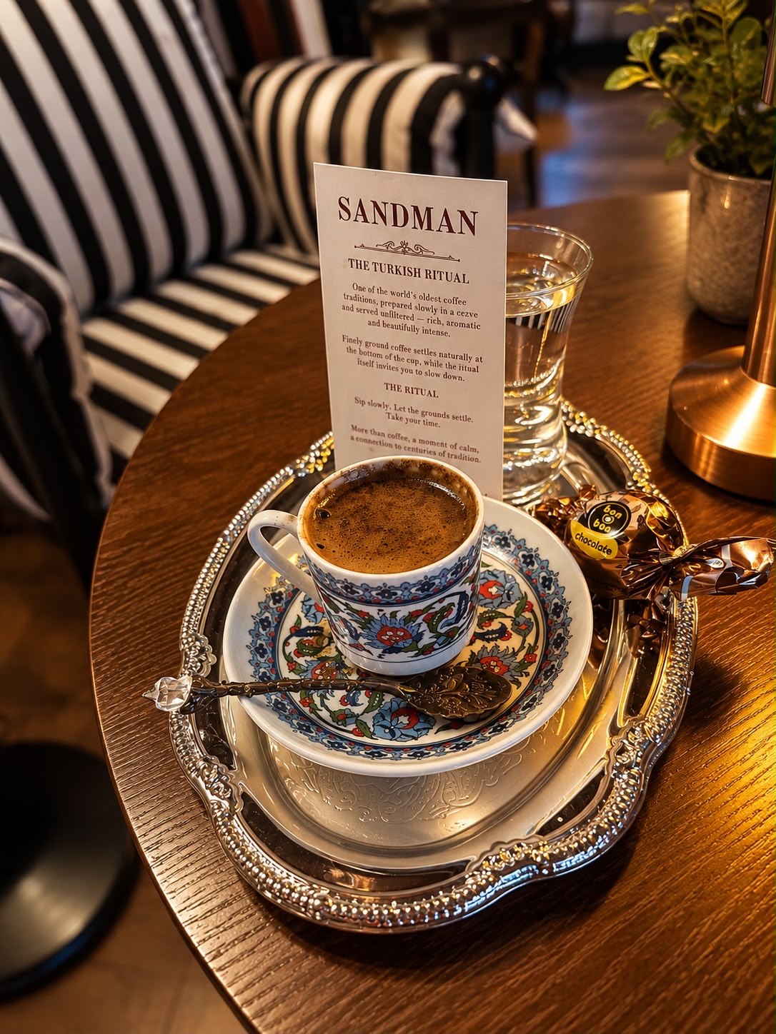 Turkish coffee in a decorative cup on a silver tray